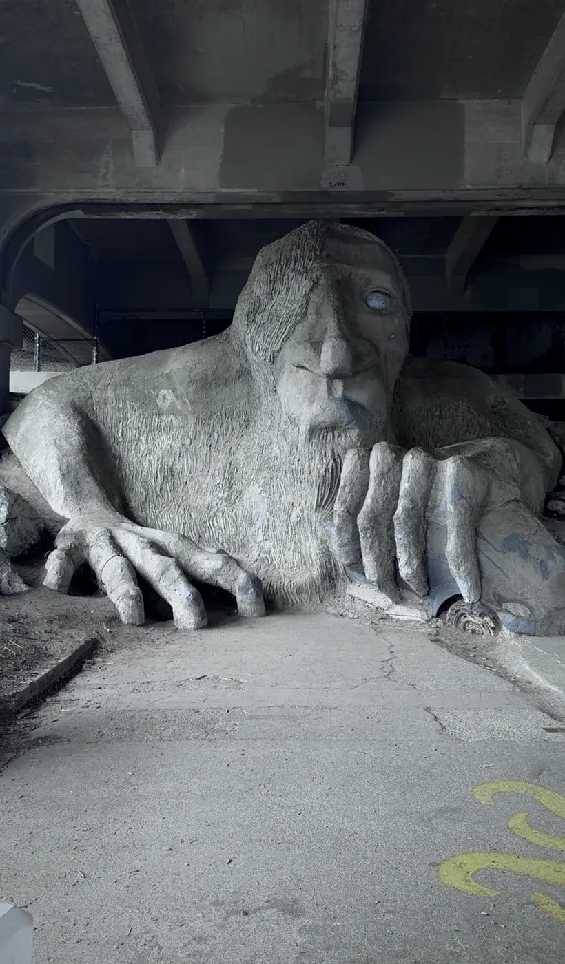 A sculpture beneath a bridge
